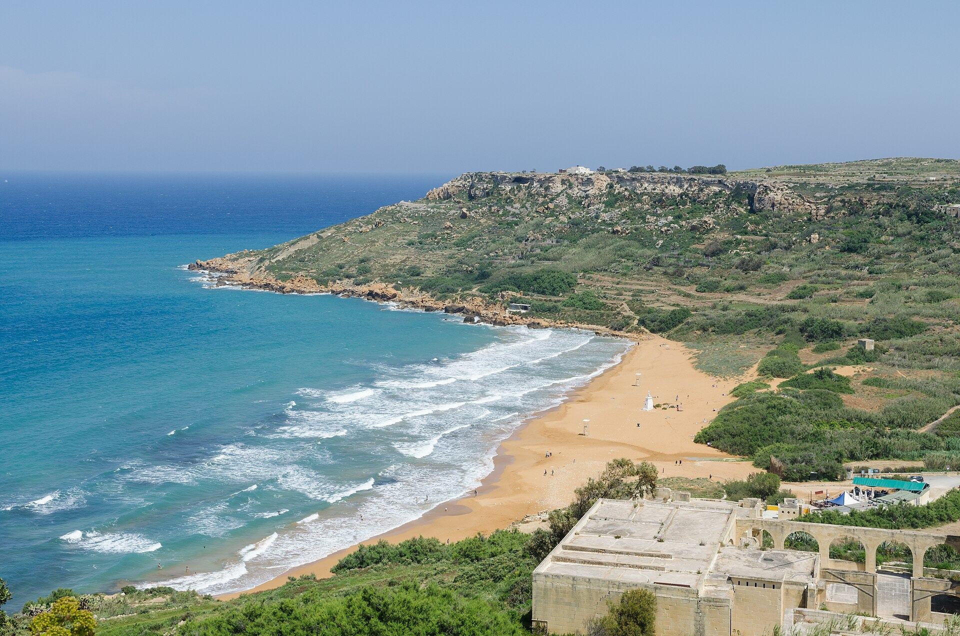 The wide orange-red sand beach at Ramla Bay, Gozo — the neighbouring bay to San Blas, on the same coast